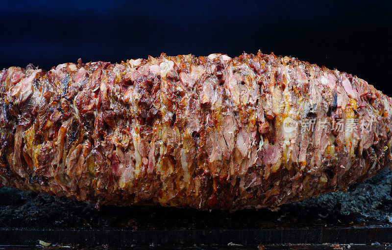 flat doner kebab meat being cut before making a sandwich cağ kebabı